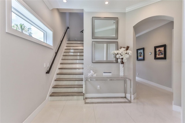 stairway featuring tile patterned floors and ornamental molding