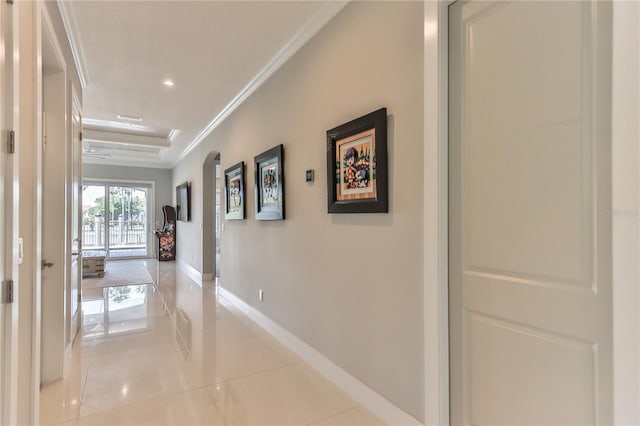 corridor with light tile patterned flooring and ornamental molding