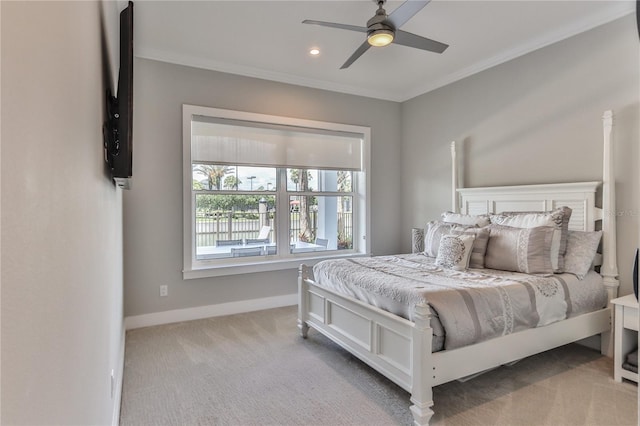 carpeted bedroom featuring crown molding and ceiling fan