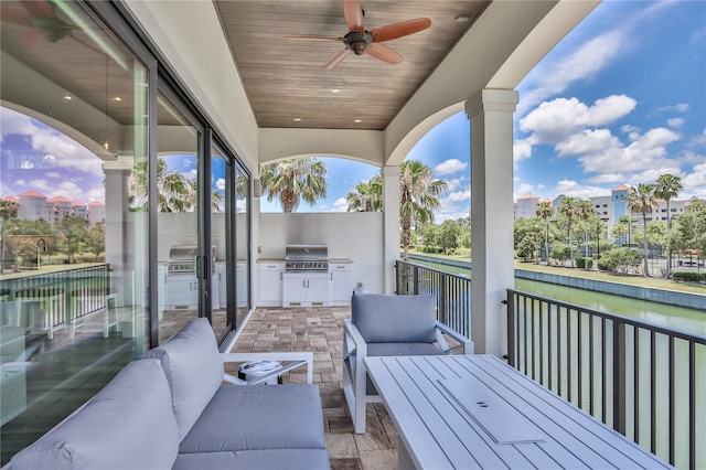 deck at dusk featuring ceiling fan, area for grilling, and outdoor lounge area