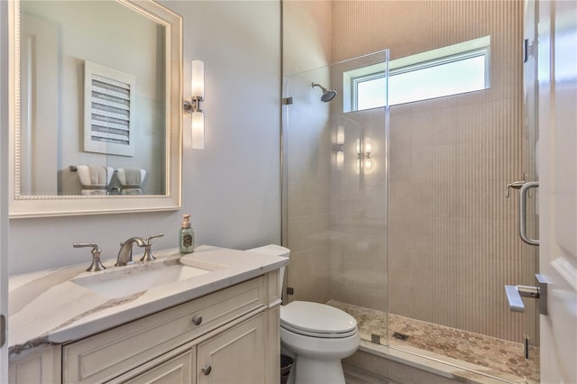 bathroom with vanity, an enclosed shower, and toilet