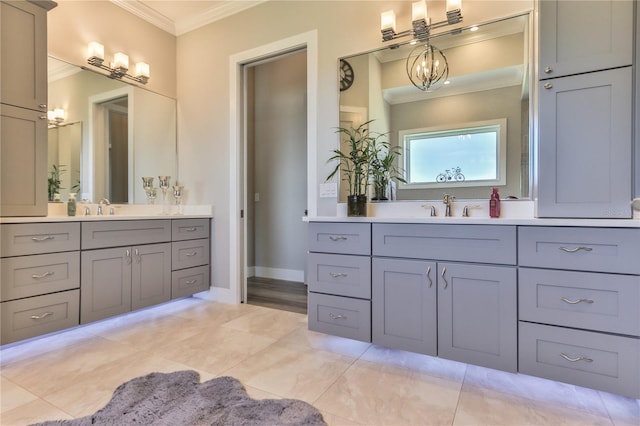 bathroom with crown molding, vanity, and a notable chandelier