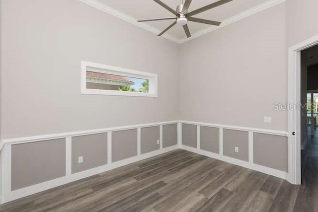 spare room featuring dark wood-type flooring, ceiling fan, and ornamental molding