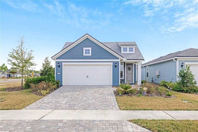 view of front of property with a garage and a front yard