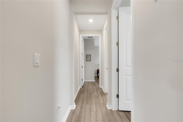 hall with light hardwood / wood-style flooring