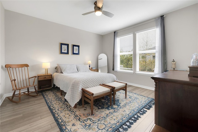 bedroom with ceiling fan and light hardwood / wood-style flooring