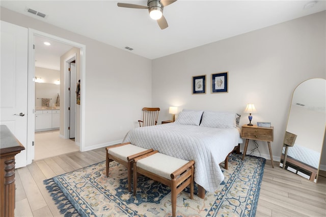 bedroom with ensuite bath, ceiling fan, and light hardwood / wood-style flooring