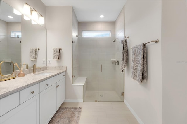bathroom with walk in shower, tile patterned floors, plenty of natural light, and vanity