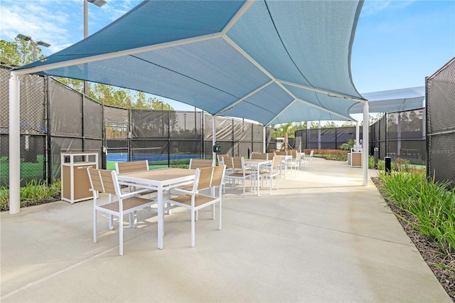 view of patio with tennis court