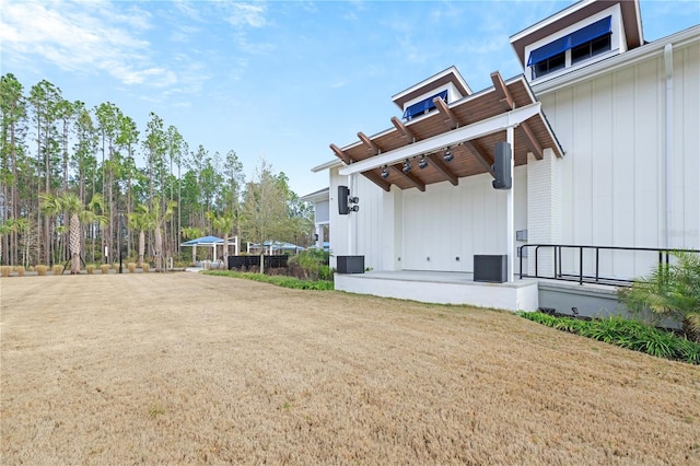 view of side of home with a yard