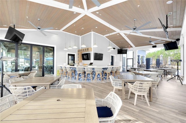 living room with ceiling fan, wooden ceiling, and high vaulted ceiling