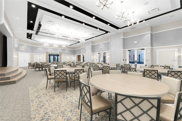 dining room with a high ceiling and a chandelier