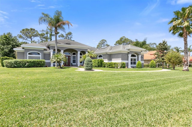 mediterranean / spanish house with a front yard