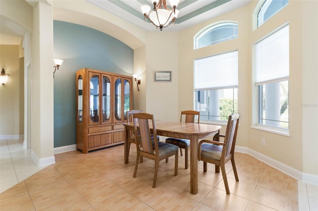 tiled dining space with a chandelier