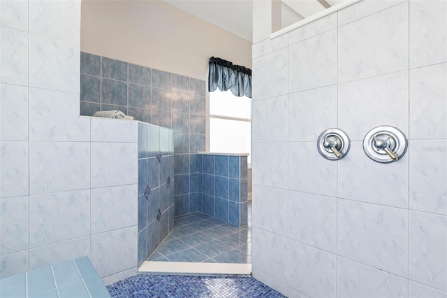 bathroom featuring a tile shower and tile patterned floors