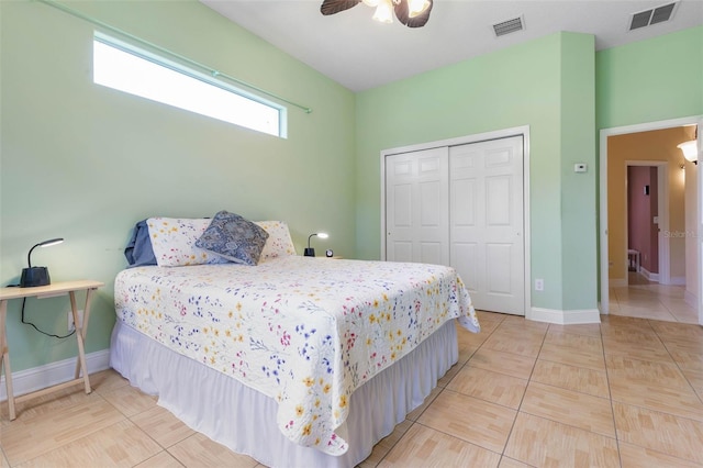 tiled bedroom featuring ceiling fan and a closet