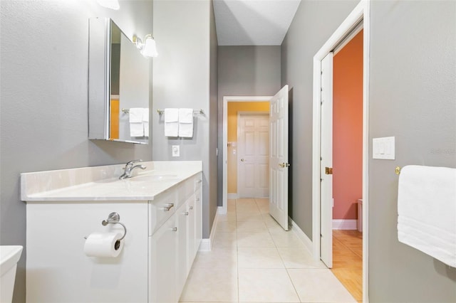 bathroom with vanity, tile patterned floors, and toilet