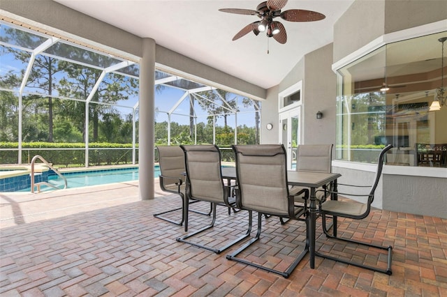 view of patio featuring ceiling fan and glass enclosure