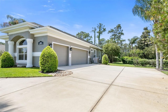 view of side of home with central AC, a garage, and a lawn