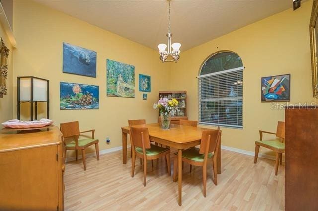 dining area with a chandelier and light wood-type flooring