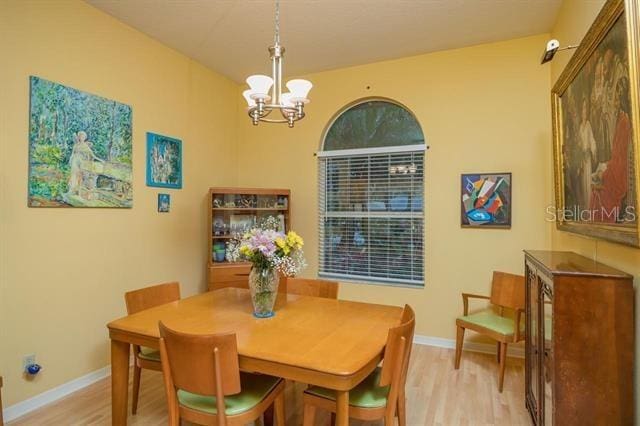 dining room with a chandelier and light hardwood / wood-style floors