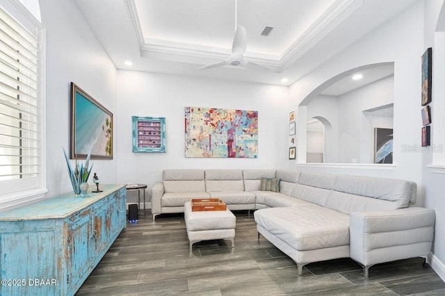 living room with ornamental molding and ceiling fan