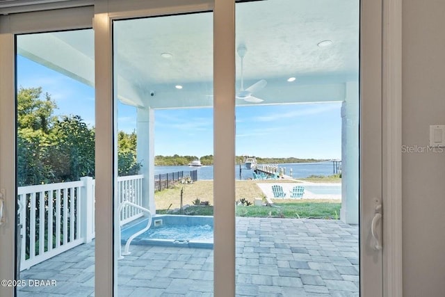 doorway to outside with a water view