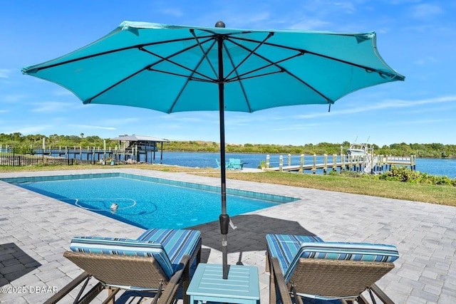 view of swimming pool featuring a patio area and a water view