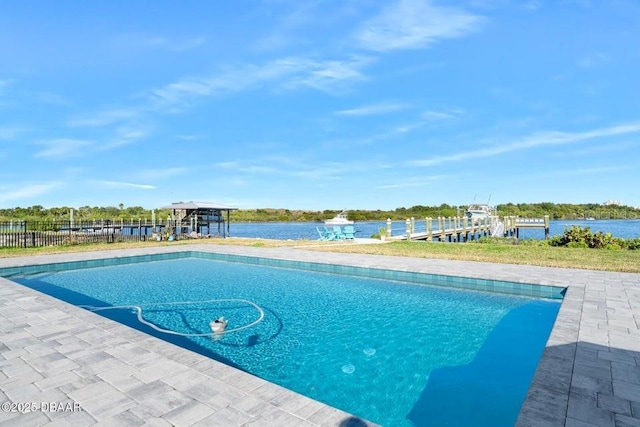 view of swimming pool with a water view and a dock