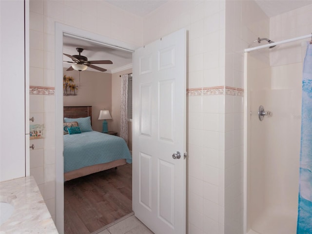 bedroom featuring crown molding, ceiling fan, and light hardwood / wood-style flooring