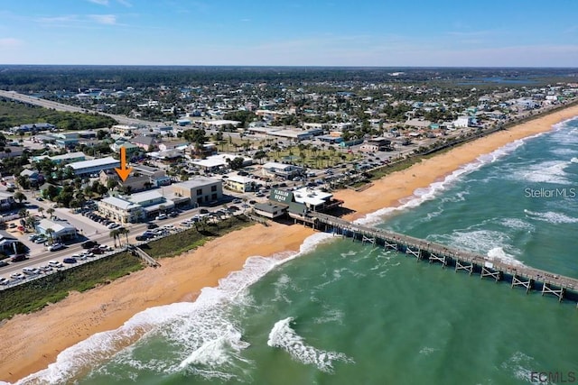 birds eye view of property featuring a water view and a beach view