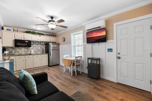 living room featuring crown molding, ceiling fan, hardwood / wood-style floors, and a wall unit AC