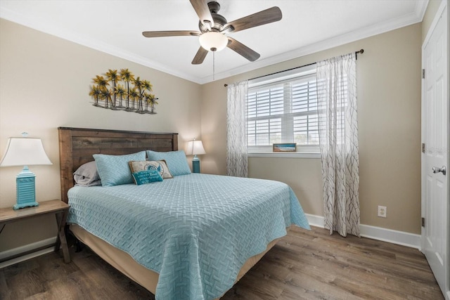 bedroom with hardwood / wood-style flooring, ornamental molding, and ceiling fan