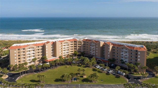 drone / aerial view featuring a water view and a beach view