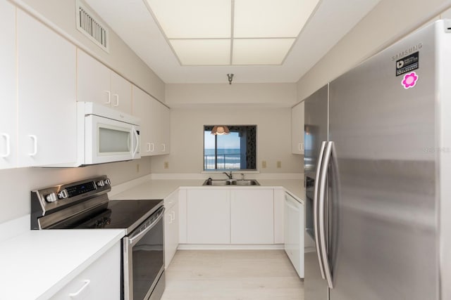 kitchen with white cabinetry, sink, and appliances with stainless steel finishes