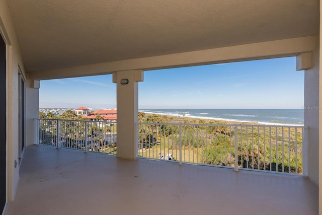 balcony with a beach view and a water view