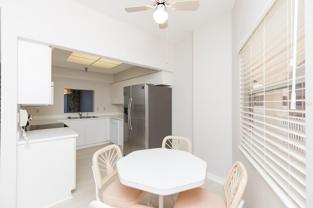 dining space with ceiling fan and light hardwood / wood-style floors