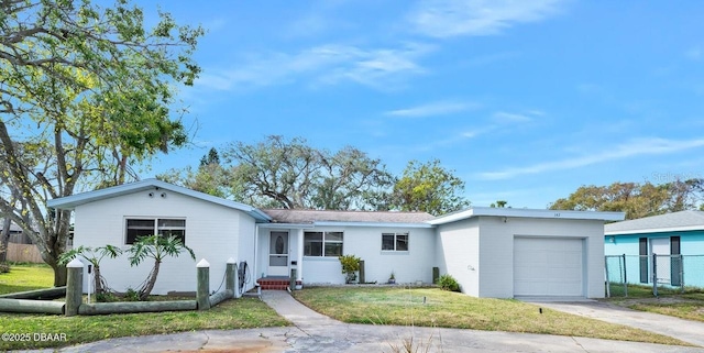 ranch-style home featuring a garage and a front yard