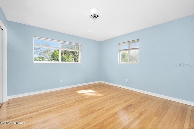 spare room featuring light wood-type flooring