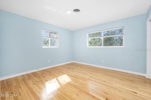 spare room with light hardwood / wood-style floors