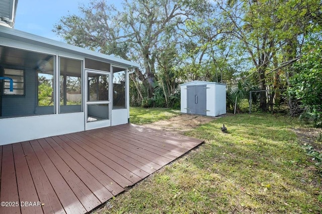 view of yard with a sunroom, a deck, and a storage shed