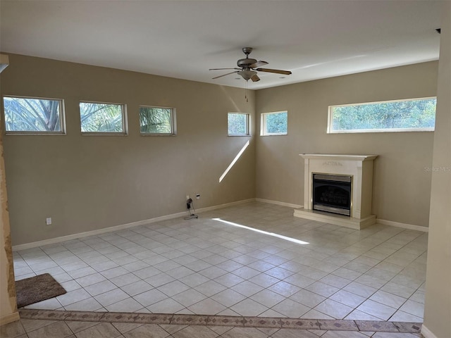 unfurnished living room featuring light tile patterned floors and ceiling fan