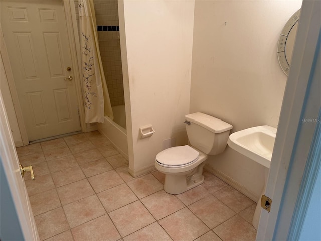 bathroom featuring toilet, tile patterned flooring, and shower / bath combo