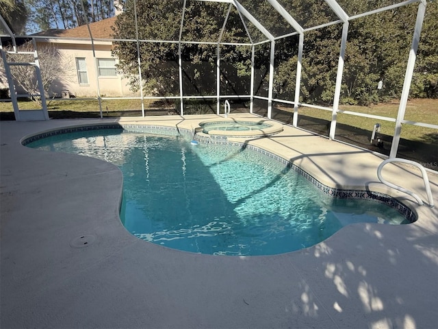 view of pool featuring a patio, glass enclosure, and an in ground hot tub