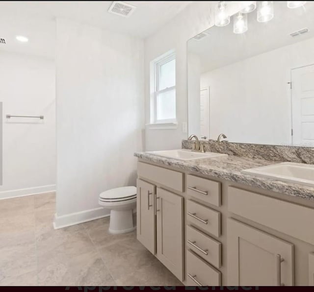 bathroom with double vanity, visible vents, toilet, and a sink