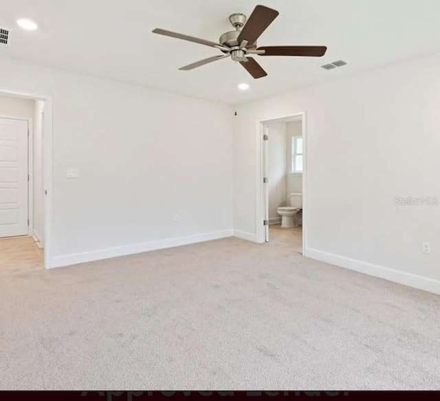 spare room with light carpet, recessed lighting, visible vents, and baseboards