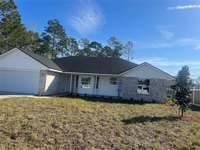 single story home with a front yard, a garage, brick siding, and driveway