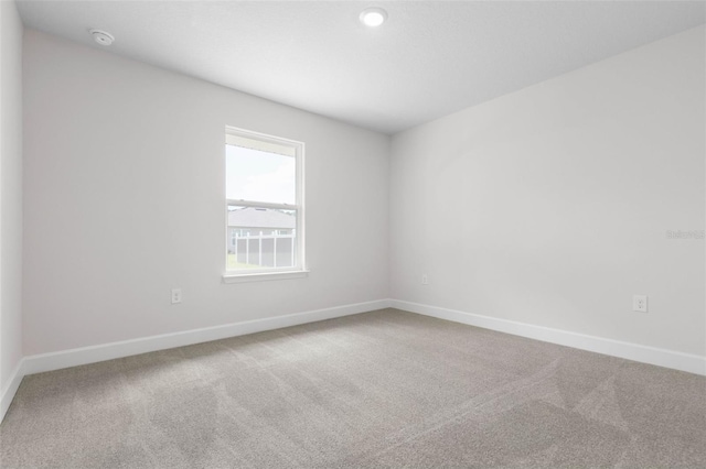 13 Primrose Ln, Palm Coast, FL 32164 - carpeted empty room with baseboards and a smoke detector