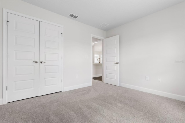 13 Primrose Ln, Palm Coast, FL 32164 - unfurnished bedroom featuring carpet floors, baseboards, and a closet
