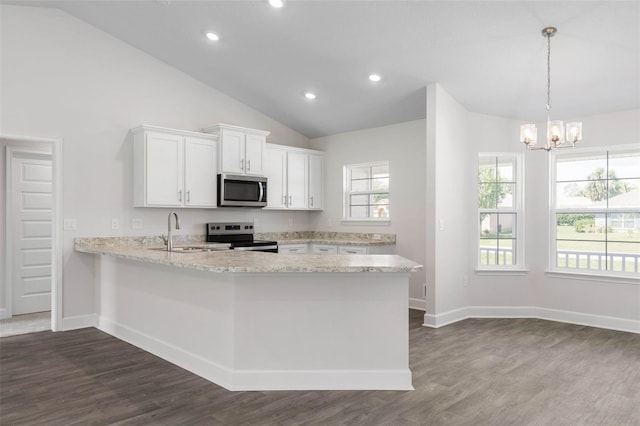 13 Primrose Ln, Palm Coast, FL 32164 - kitchen featuring appliances with stainless steel finishes, a sink, lofted ceiling, white cabinetry, and dark wood-style flooring